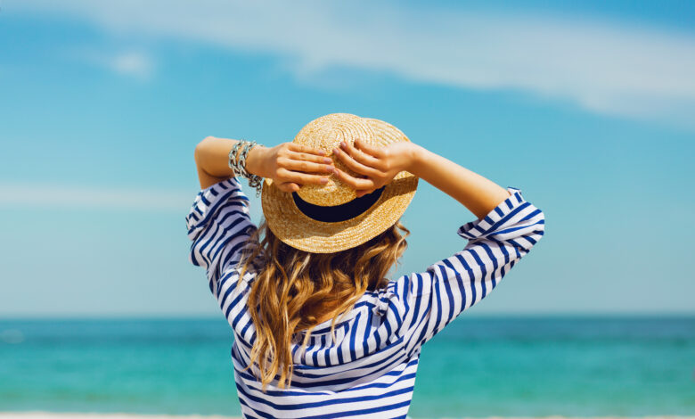 Summer Vacation girl on beach wearing hat